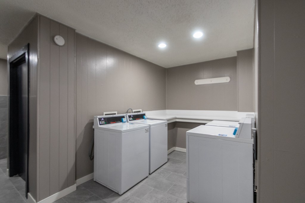 This is a photo of one of the seven community clothes centers at Cambridge Court Apartments in Dallas, TX.