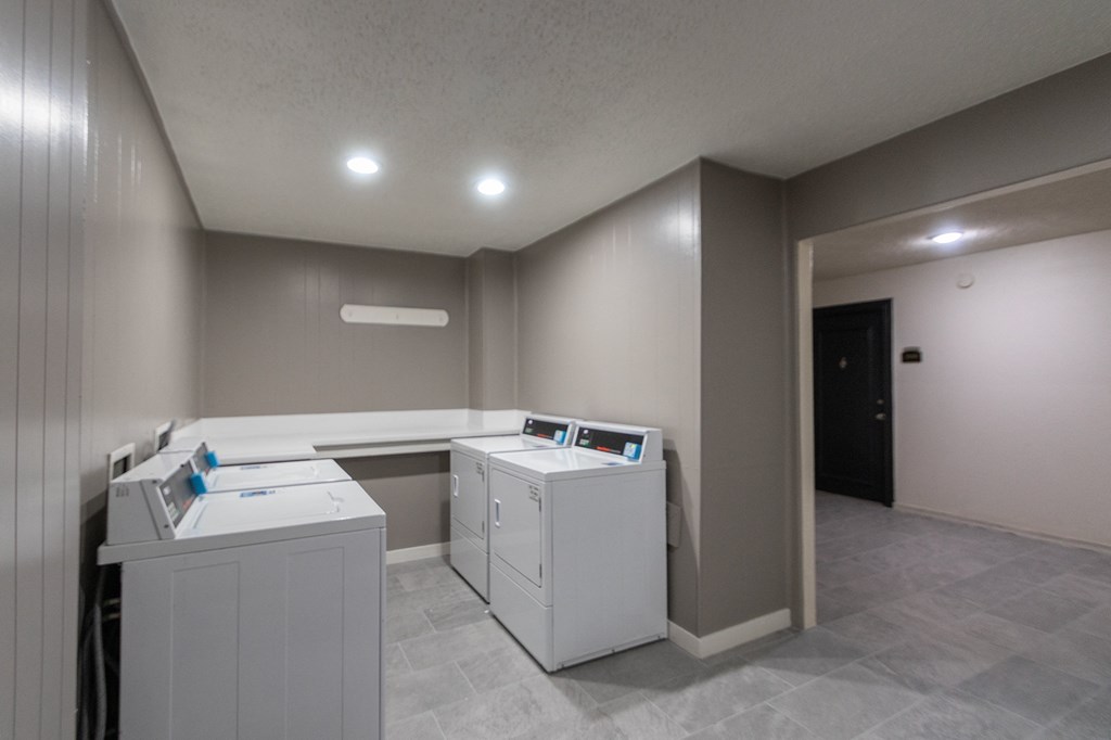 This is a photo of one of the seven community clothes centers at Cambridge Court Apartments in Dallas, TX.