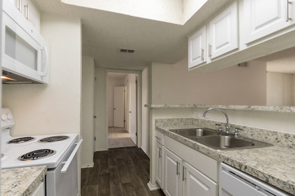 This is a photo of the kitchen in the 880 square foot 2 bedroom, 2 bath apartment at Canyon Creek Apartments in Dallas, TX