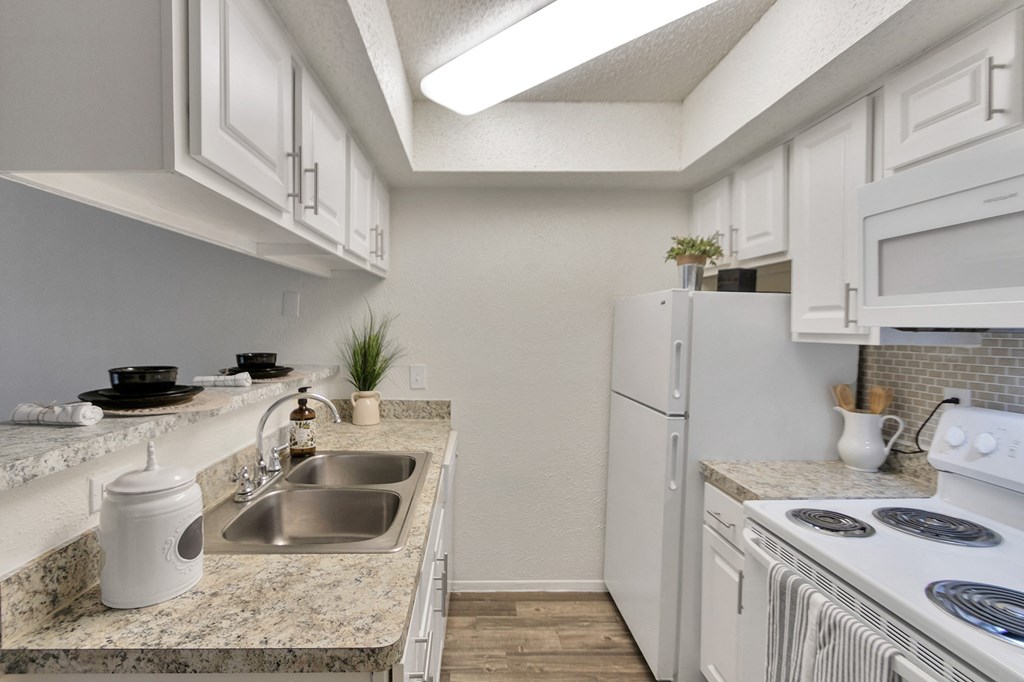 Kitchen With White Appliances at Canyon Creek, Dallas, Texas