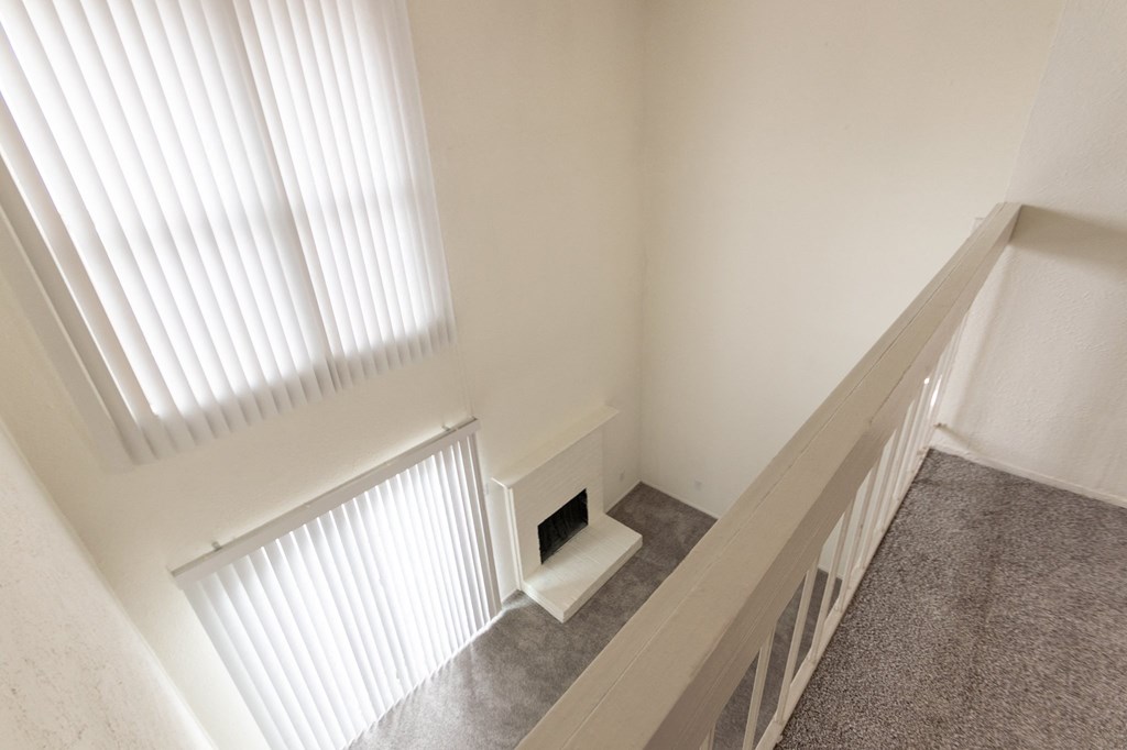 This is a photo of the living room from the loft/bedroom in a 717 square foot 1 bedroom, 1 bath apartment at Canyon Creek Apartments in Dallas, TX