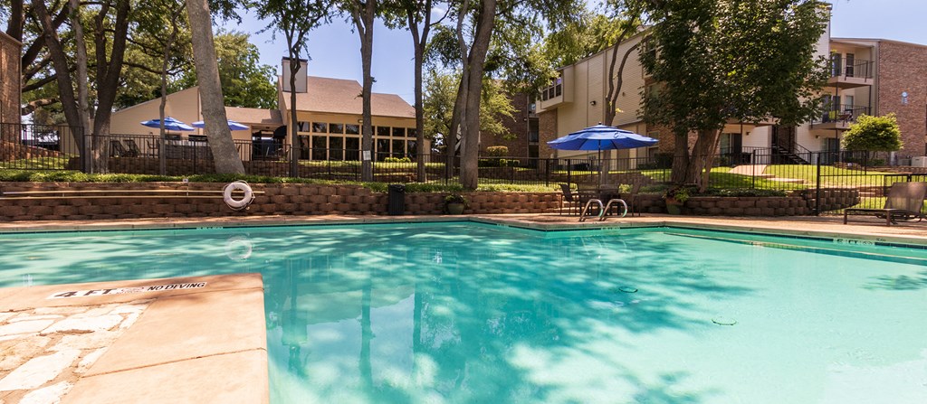 This is a photo of the pool area at Canyon Creek Apartments in Dallas, TX.