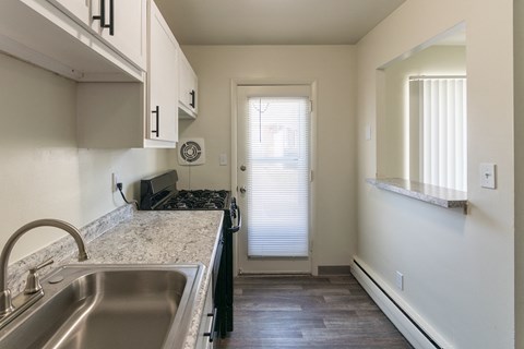 This is a photo of the kitchen with pass through window in the 631 square foot, B-style (Ranch) 1 bedroom/1 bath floor plan at Colonial Ridge Apartments in the Pleasant Ridge neighborhood of Cincinnati, OH.