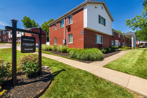 Colonial Ridge Apartments sign with brick apartment homes and landscaped lawn in Pleasant Ridge