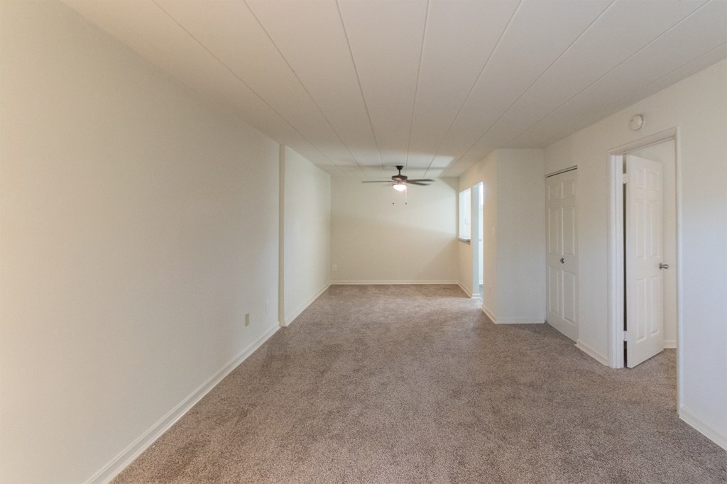 This is a photo of the living room and dining area in the 550 square foot 1 bedroom, 1 bath patio apartment at College Woods Apartments in the North College Hill neighborhood of Cincinnati, OH.