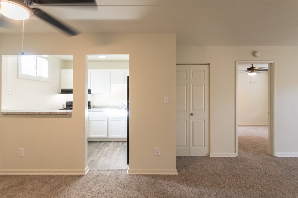 This is a photo looking into the kitchen from the dining area and living room in the 550 square foot 1 bedroom, 1 bath patio apartment at College Woods Apartments in the North College Hill neighborhood of Cincinnati, OH.