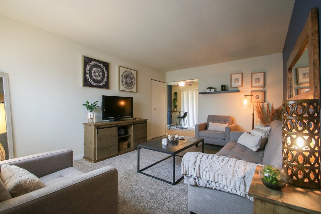 This is a photo of the living room of the 550 square foot 1 bedroom, 1 bath, balcony floor plan model apartment at College Woods Apartments in Cincinnati, OH.