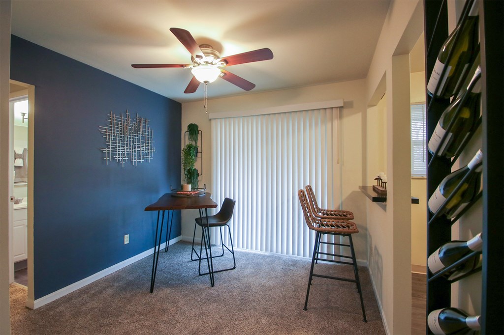 This is a photo of the dining area of the 550 square foot 1 bedroom, 1 bath, balcony floor plan model apartment at College Woods Apartments in Cincinnati, OH.