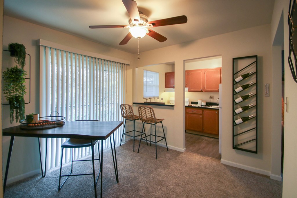 This is a photo of the dining area of the 550 square foot 1 bedroom, 1 bath, balcony floor plan model apartment at College Woods Apartments in Cincinnati, OH.