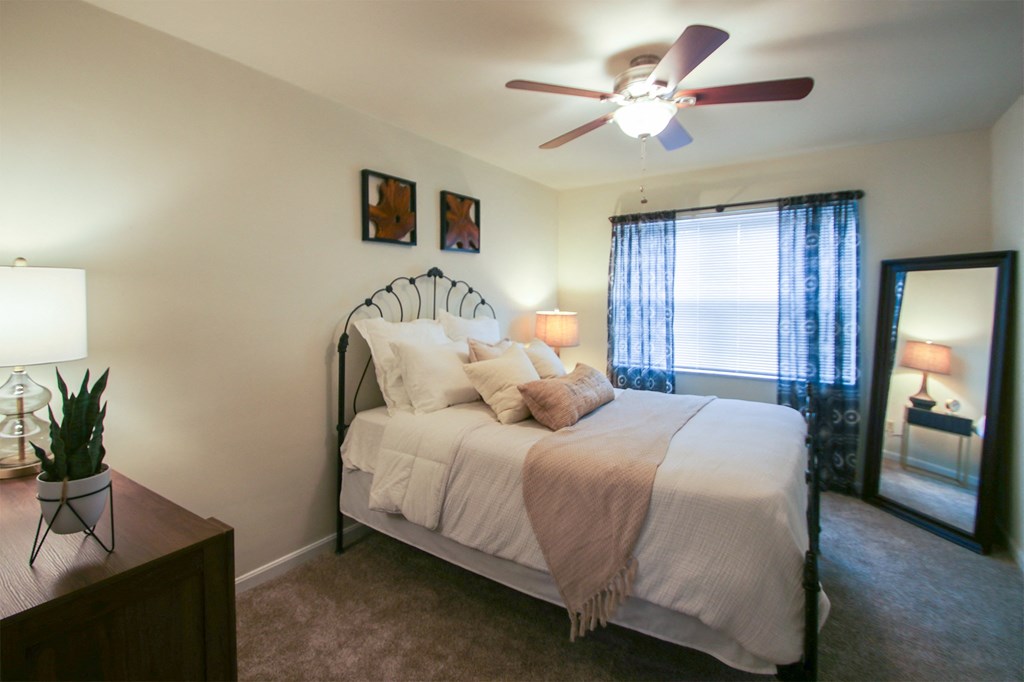 This is a photo of the bedroom of the 550 square foot 1 bedroom, 1 bath, balcony floor plan model apartment at College Woods Apartments in Cincinnati, OH.