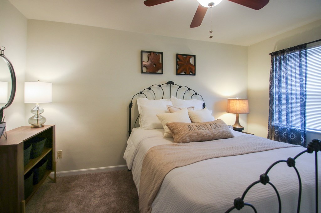 This is a photo of the bedroom of the 550 square foot 1 bedroom, 1 bath, balcony floor plan model apartment at College Woods Apartments in Cincinnati, OH.