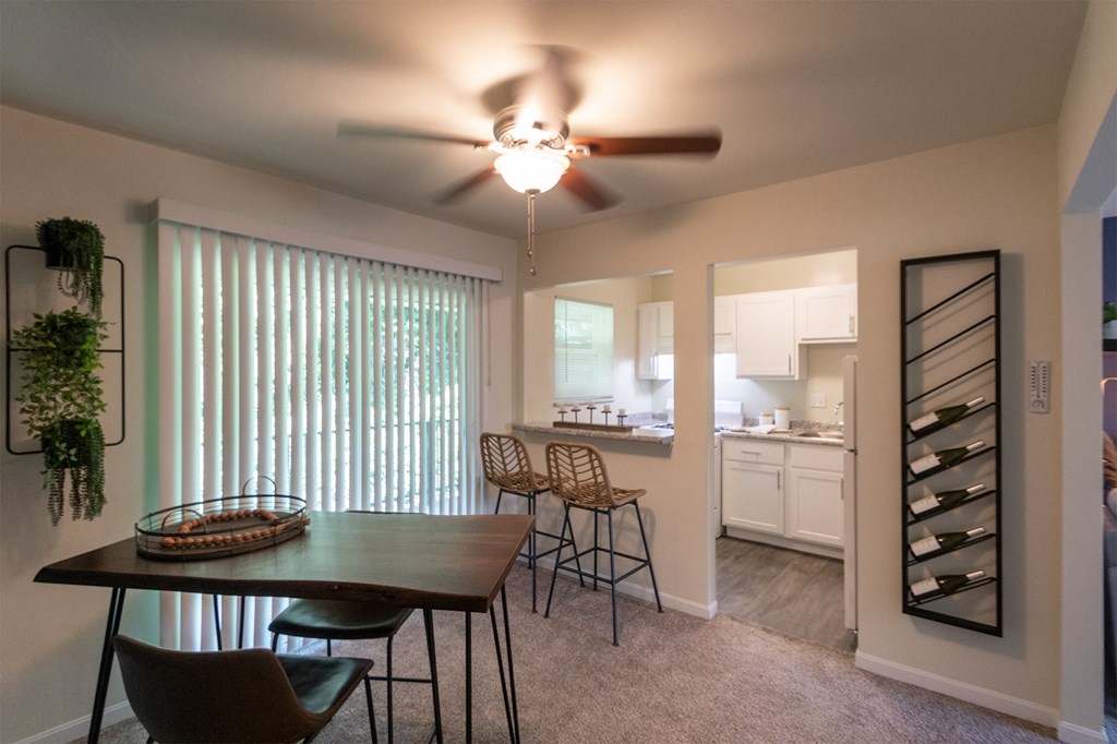 This is a photo of the kitchen from the dining room with pass through breakfast bar of the 550 square foot 1 bedroom, 1 bath, balcony floor plan model apartment at College Woods Apartments in thne NOrth College Hill neighborhood of Cincinnati, OH.