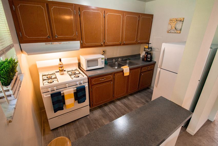 This is a photo of the kitchen of the 550 square foot 1 bedroom, balcony floor plan model apartment at College Woods Apartments in Cincinnati, OH. - Photo Gallery 1