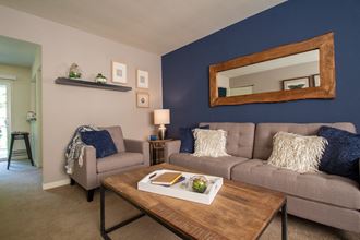This is a photo of the living room of the 550 square foot 1 bedroom, balcony floor plan model apartment at College Woods Apartments in Cincinnati, OH. - Photo Gallery