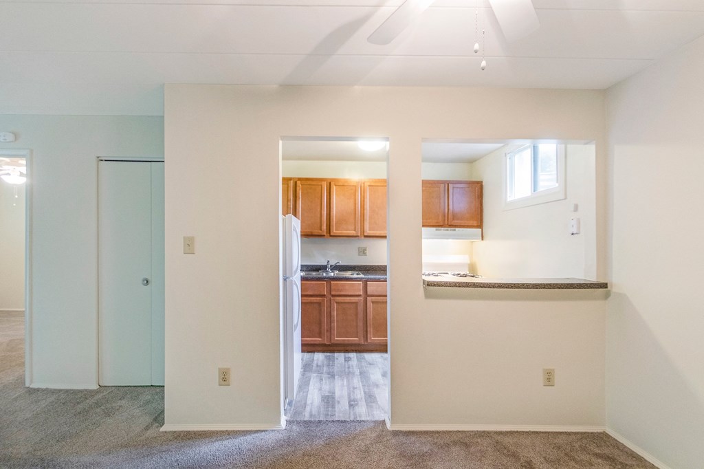 This is a photo of the kitchen from the dining room of the 550 square foot 1 bedroom, 1 bath patio apartment at College Woods Apartments in the North College Hill neighborhood of Cincinnati, OH.