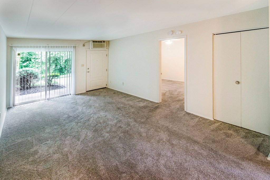 This is a photo of the living room of the 550 square foot 1 bedroom, 1 bath patio apartment at College Woods Apartments in the North College Hill neighborhood of Cincinnati, OH.