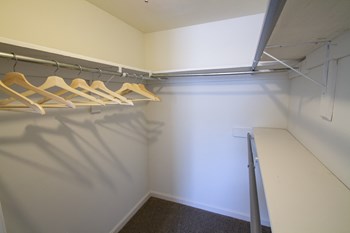 This is a picture of the primary bedroom walk-in closet in an upgraded 980 square foot, 2 bedroom, 1 bath model apartment at Fairfield Pointe Apartments in Fairfield, Ohio. - Photo Gallery 24