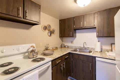 This is a picture of the kitchen in the 980 square foot, 2 bedroom, 1 bath model apartment at Fairfield Pointe Apartments in Fairfield, Ohio.