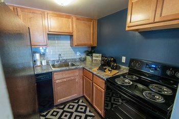 This is a picture of the kitchen in an upgraded 980 square foot, 2 bedroom, 1 bath model apartment at Fairfield Pointe Apartments in Fairfield, Ohio. - Photo Gallery 2