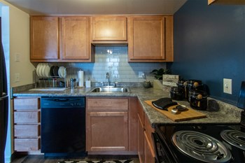 This is a picture of the kitchen in an upgraded 980 square foot, 2 bedroom, 1 bath model apartment at Fairfield Pointe Apartments in Fairfield, Ohio. - Photo Gallery 3