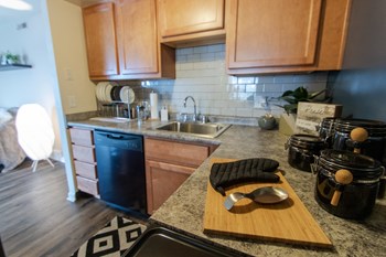 This is a picture of the kitchen in an upgraded 980 square foot, 2 bedroom , 1 bath model apartment at Fairfield Pointe Apartments in Fairfield, Ohio. - Photo Gallery 4