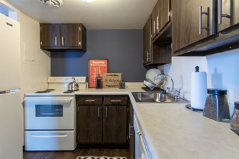 This is a picture of the kitchen in the 980 square foot, 2 bedroom, 1 bath model apartment at Fairfield Pointe Apartments in Fairfield, Ohio. - Photo Gallery 5
