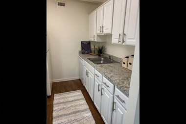 This is a photo of the kitchen in the 965 square foot 1 bedroom, 1 bath  apartment at Harvard Square Apartments, in the Vickery Meadow neighborhood of Dallas, TX.