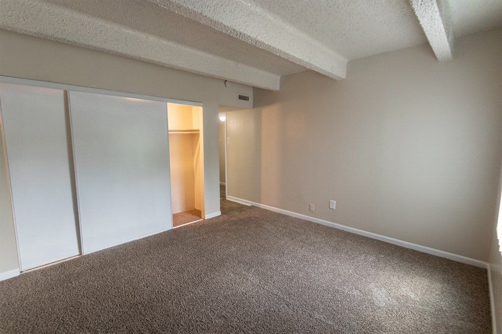 This is a photo of the primary bedroom in the 965 square foot 2 bedroom, 2 bath  apartment at Harvard Square Apartments, in Dallas, TX.