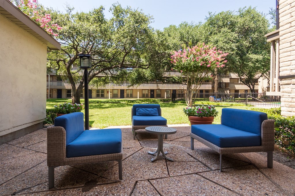This is a photo of a sitting area in the courtyard at Harvard Square Apartments, in the Vickery Meadow neighborhood of Dallas, TX.