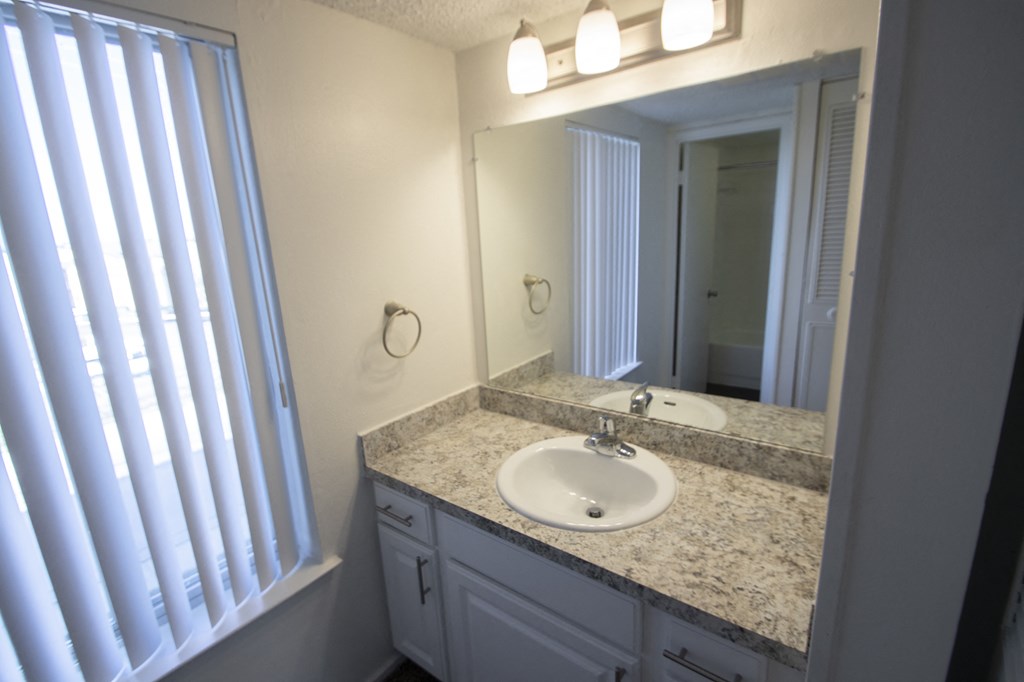 This is a photo of the bathroom vanity in the 500 square foot 1 bedroom apartment at Harvard Square Apartments, in Dallas, TX.