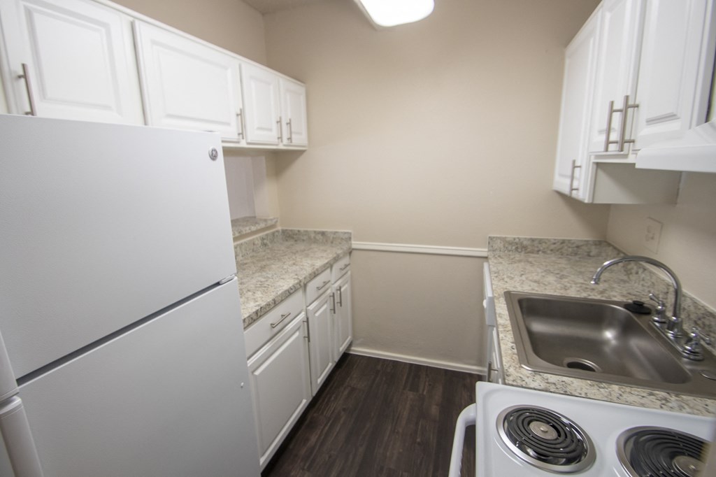 This is a photo of the kitchen in the 653 square foot 1 bedroom apartment at Harvard Square Apartments, in Dallas, TX.