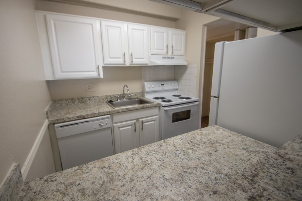 This is a photo of the kitchen in the 653 square foot 1 bedroom apartment at Harvard Square Apartments, in Dallas, TX.