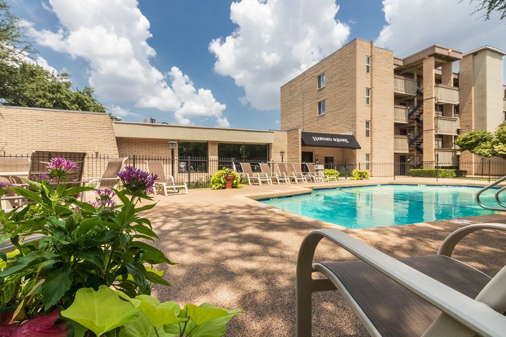 This is a photo of the pool area in the courtyard at Harvard Square Apartments, in the Vickery Meadow neighborhood of Dallas, TX.