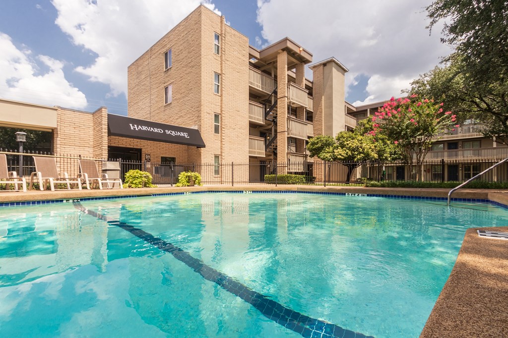This is a photo of the pool area in the courtyard at Harvard Square Apartments, in the Vickery Meadow neighborhood of Dallas, TX.