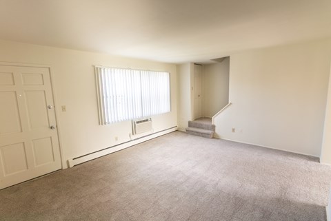 This is a photo of the living room in the 1004 square foot, 2 bedroom, 1.5 bath townhome floor plan at Lake of the Woods Apartments in Cincinnati, OH.