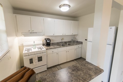 This is a photo of the kitchen of the 1 bedroom, 631 square foot model apartment at Lake of the Woods Apartments in Cincinnati, OH.