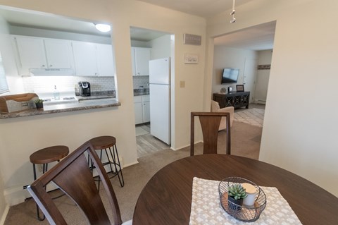 This is a photo of the kitchen and living room from the dining room of the 1 bedroom, 631 square foot model apartment at Lake of the Woods Apartments in Cincinnati, OH.