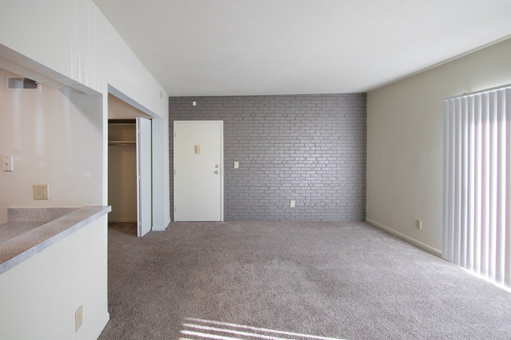 This is a photo the living room with painted brick accent wall of the 833 square foot Chestnut, 2 bedroom apartment at Montana Valley Apartments in Cincinnati, OH.