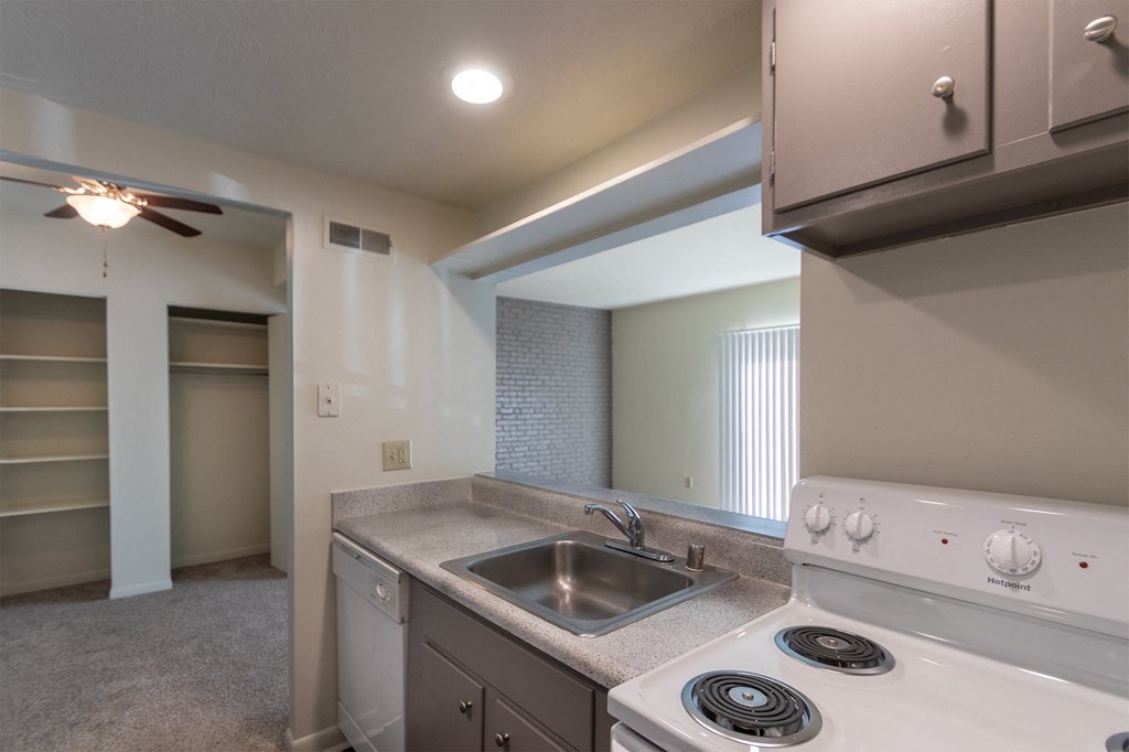 This is a photo the dining area and living room from the kitchen of the 833 square foot Chestnut, 2 bedroom apartment at Montana Valley Apartments in Cincinnati, OH.