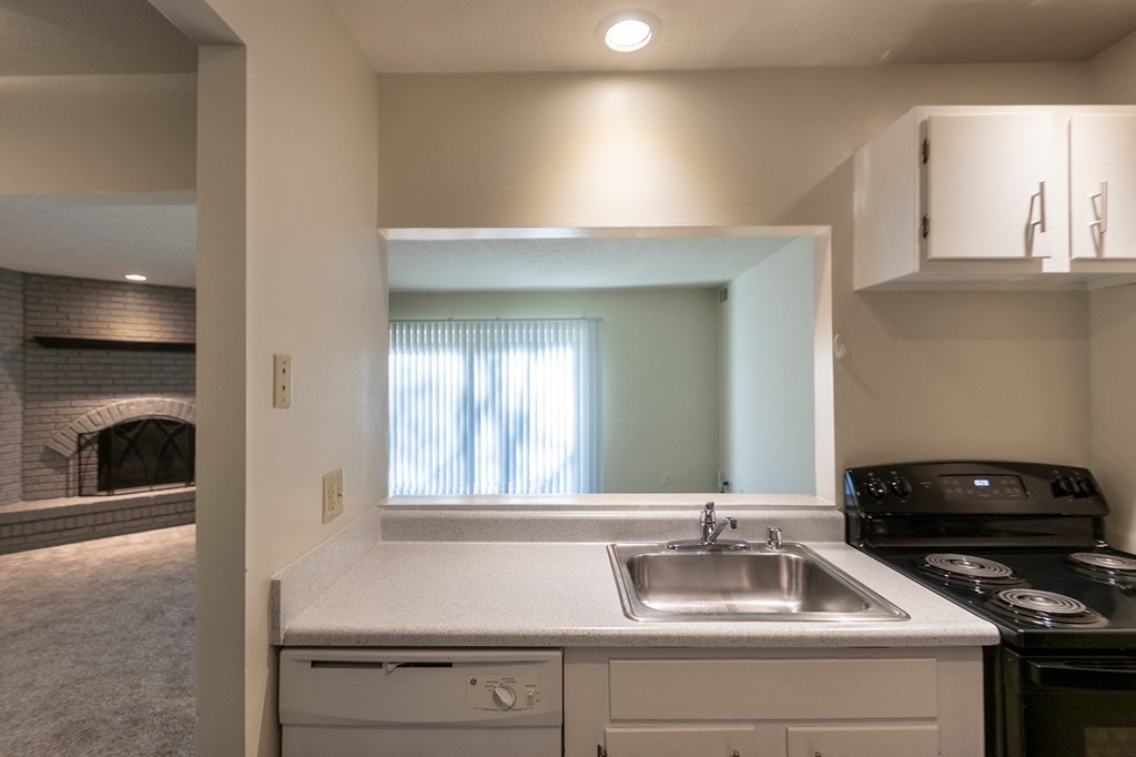 This is a photo the kitchen with white cabinets in the 925 square foot, Hazelnut 2 bedroom, 1 bath apartment at Montana Valley Apartments in the Westwood neighborhood of Cincinnati, OH.