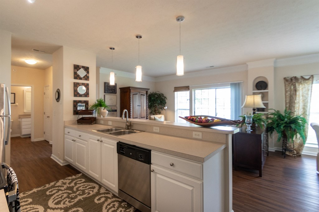 This is a photo of the living room from the kitchen in the 2 bedroom, 2 bath Islander floor plan at Nantucket Apartments in Loveland, OH.