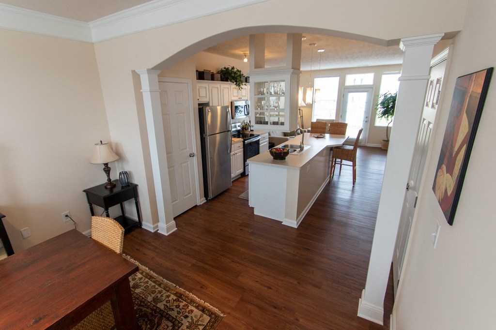 This is a photo of the dining room and kitchen from the stairwell in the 1242 square foot, 2 bedroom, 2 and 1/2 bath Spinnaker floor plan at Nantucket Apartments in Loveland, OH.