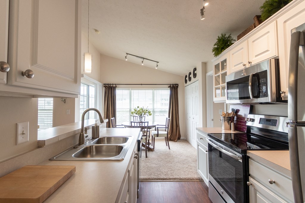 This is a photo of the dining area from the kitchen in the 1016 square foot, 2 bedroom, 2 bath Nautica floor plan at Nantucket Apartments in Loveland, OH.