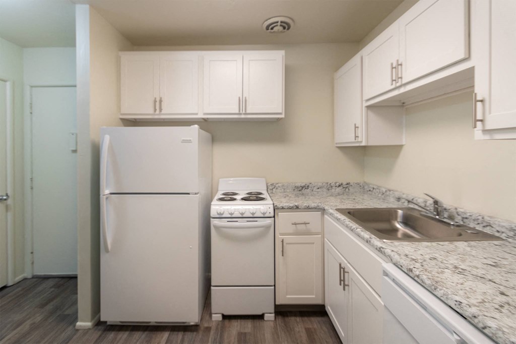This is a photo of a kitchen with white cabinets and white appliances in a 560 square foot 1, 1 bath apartment at Park Lane Apartments in Cincinnati, OH.