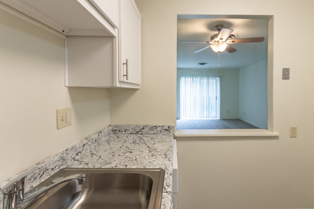 This is a photo of a kitchen with white cabinets and white appliances in a 560 square foot 1, 1 bath apartment at Park Lane Apartments in Cincinnati, OH.