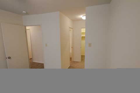 This is a photo looking towards the primary bathroom and walk-in closet in the primary bedroom in a 849 square foot 2 bedroom, 2 bath apartment at Park Lane Apartments in Cincinnati, OH.