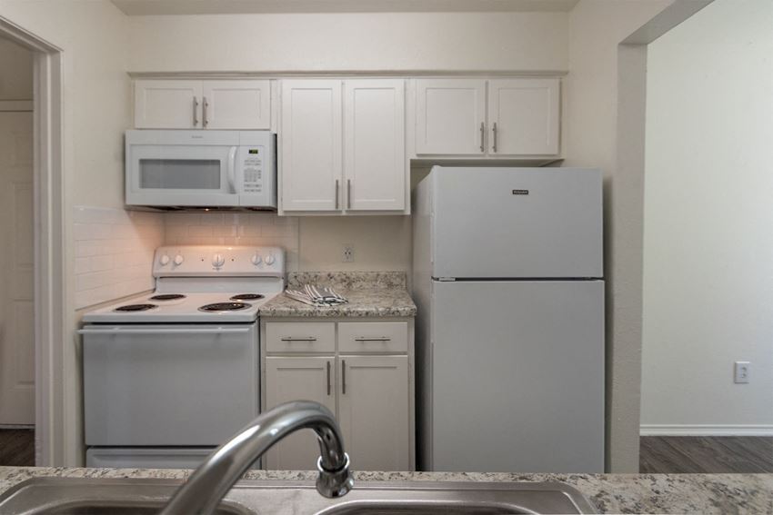 This is a photo of the kitchen in the 970 square foot 2 bedroom, 2 bath apartment at Preston Park Apartments in Dallas, TX - Photo Gallery