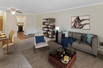 This is a photo of the digitally staged living room of a 742 square foot, 2 bedroom apartment at Romaine Court Apartments in Cincinnati, Ohio. - Photo Gallery 11