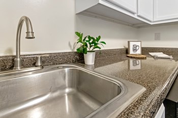 This is a photo of the kitchen of a 742 square foot, 2 bedroom apartment at Romaine Court Apartments in the Oakley neighborhood of Cincinnati, Ohio. - Photo Gallery 9