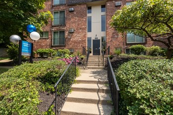 This is a photo of the building entrance to the leasing office at Romaine Court Apartments in the Oakley neighborhood of Cincinnati, Ohio. - Photo Gallery 46